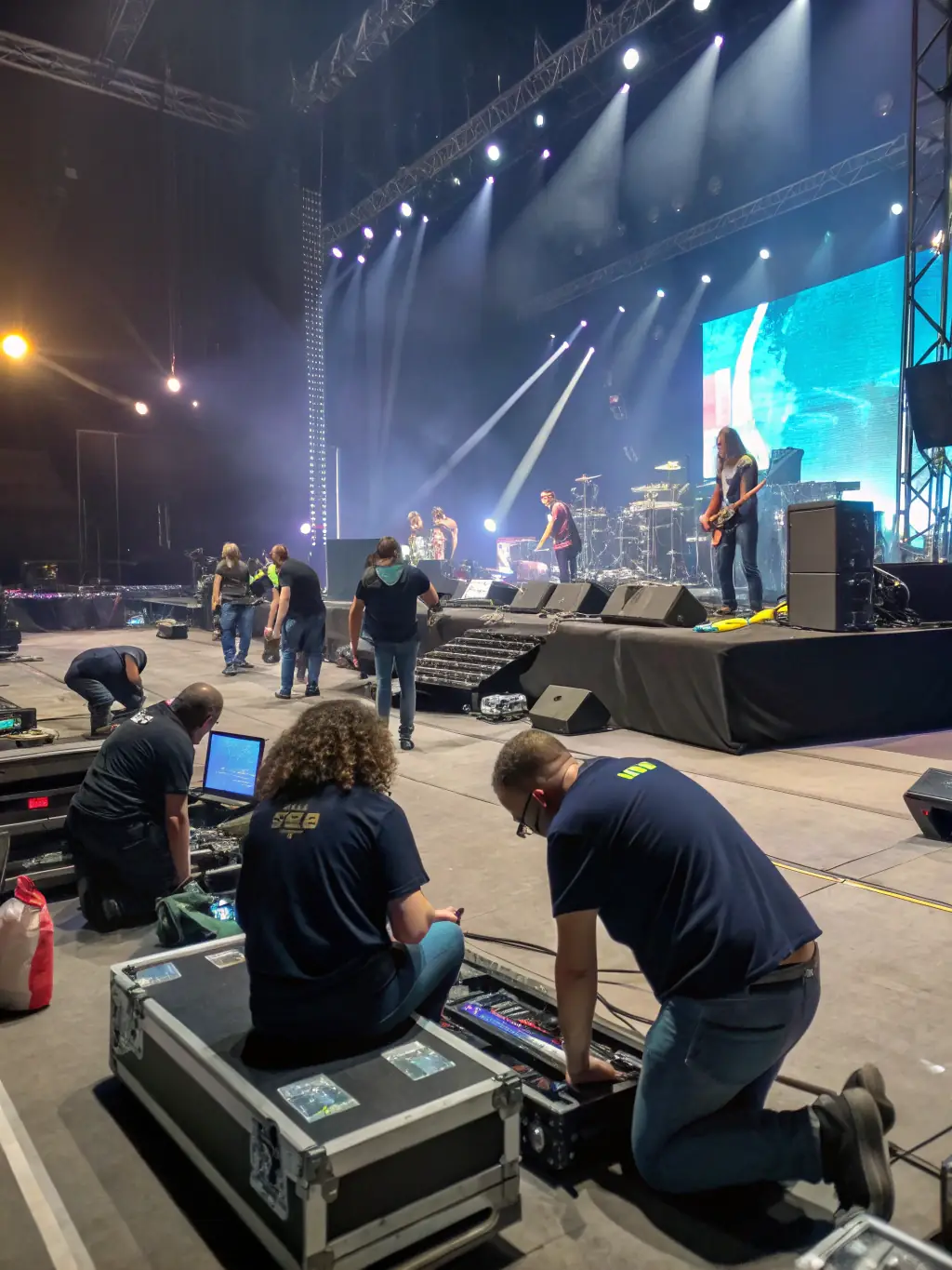 A photo of volunteers setting up for a music event organized by ASSOCIATION MANGO, showcasing the organization's commitment to community involvement and cultural enrichment.